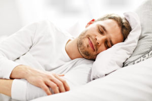Young man sleeping in bed